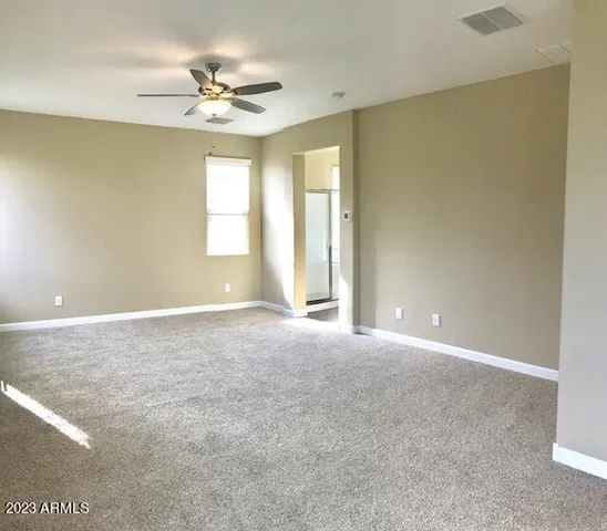 a view of a livingroom with a ceiling fan and window