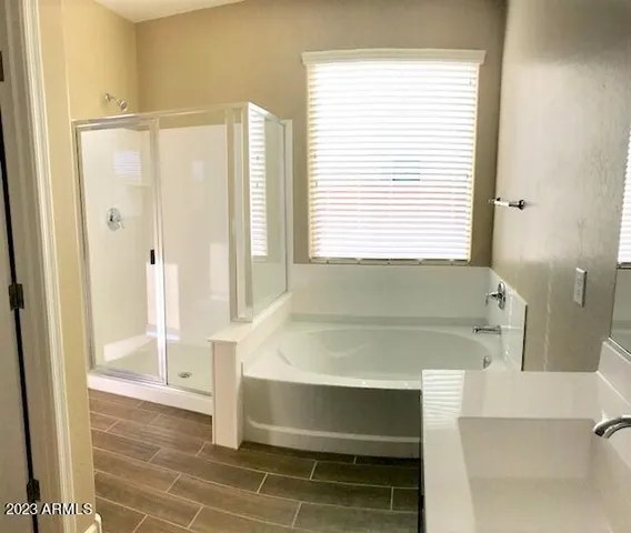 a bathroom with a tub shower and a sink