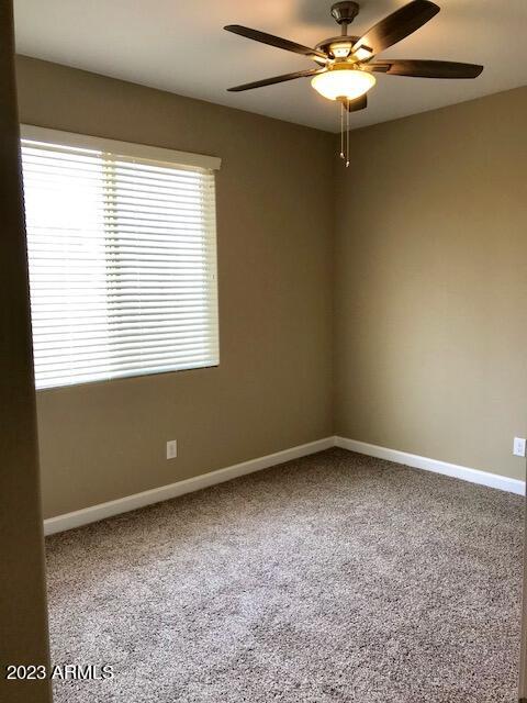 13655 West Briles Road Peoria, AZ 85383 - Photo 15 of 20 an empty room with a window and a fan