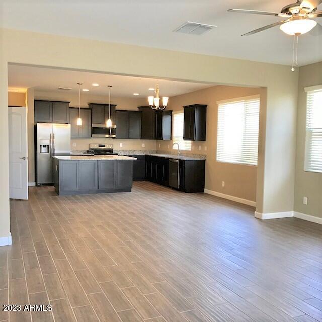 13655 West Briles Road Peoria, AZ 85383 - Photo 5 of 20 a large kitchen with a lot of counter space and wooden floor