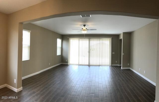 13655 West Briles Road Peoria, AZ 85383 - Photo 9 of 20 an empty room with wooden floor and windows