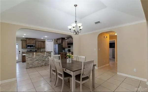 a dining room with furniture and chandelier