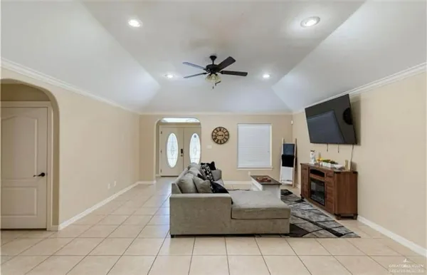 a living room with fireplace furniture and a flat screen tv