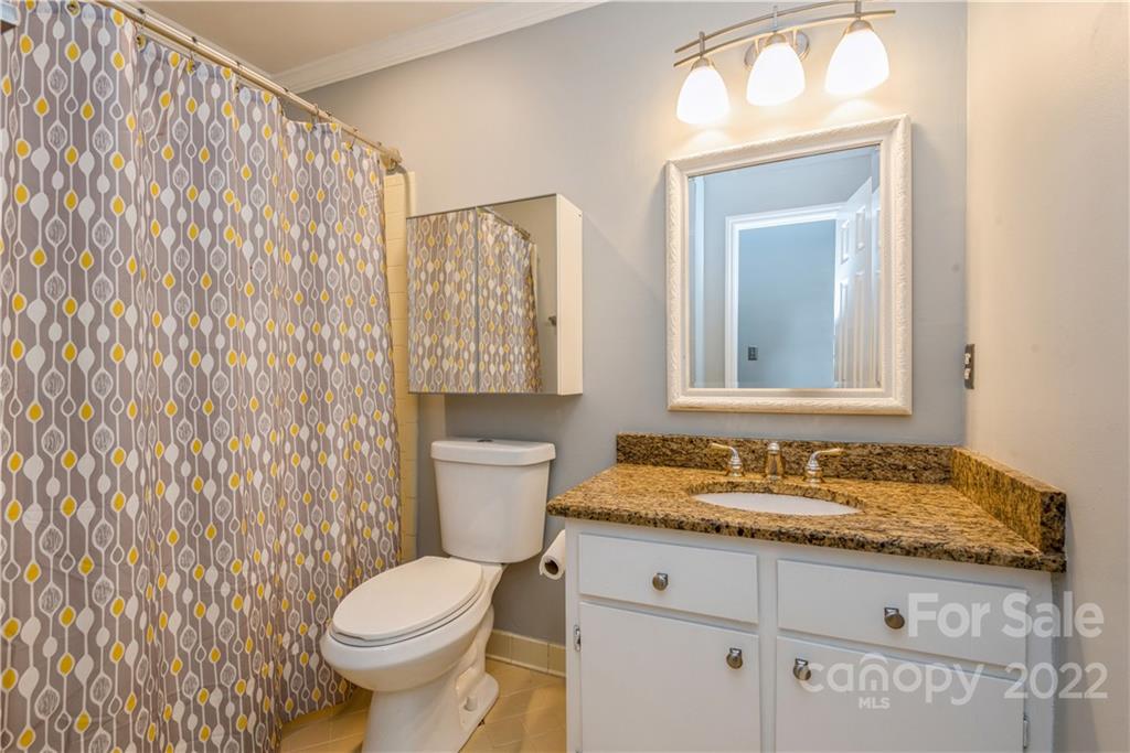 7607 Alexander Road Charlotte, NC 28270 - Photo 17 of 34 a bathroom with a granite countertop sink and a mirror
