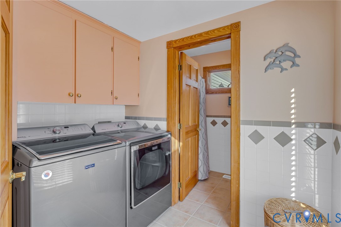 273 Sutton Avenue Reedville, VA 22539 - Photo 12 of 50 a utility room with cabinets washer and dryer