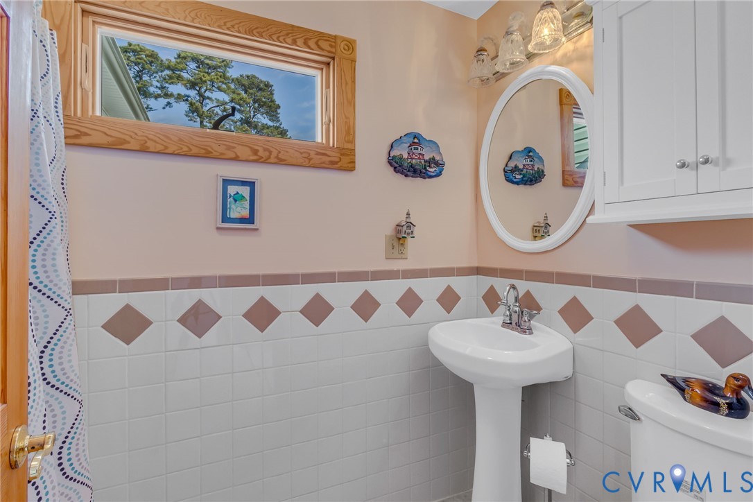 273 Sutton Avenue Reedville, VA 22539 - Photo 13 of 50 a bathroom with a sink and a mirror