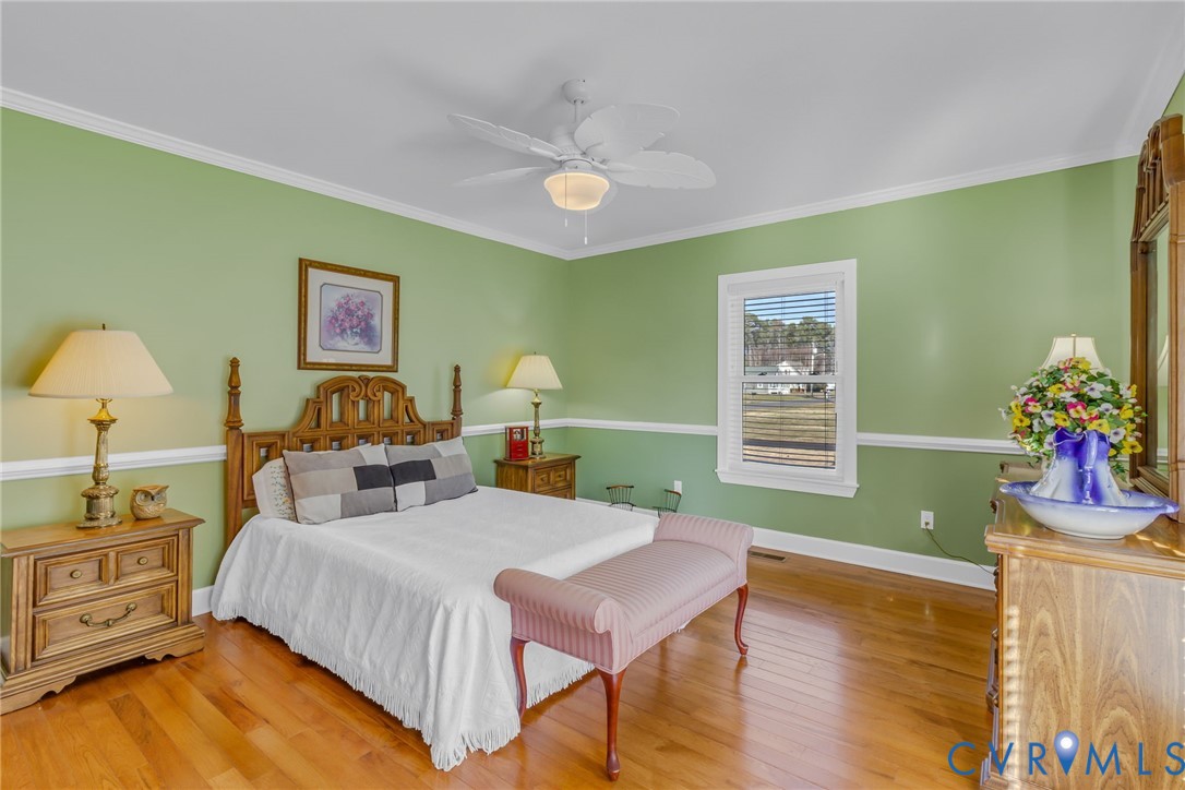 273 Sutton Avenue Reedville, VA 22539 - Photo 18 of 50 a bed room with a bed and a chair