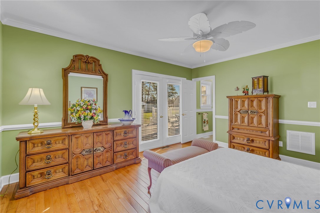 273 Sutton Avenue Reedville, VA 22539 - Photo 21 of 50 a bedroom with a bed and a dresser in it