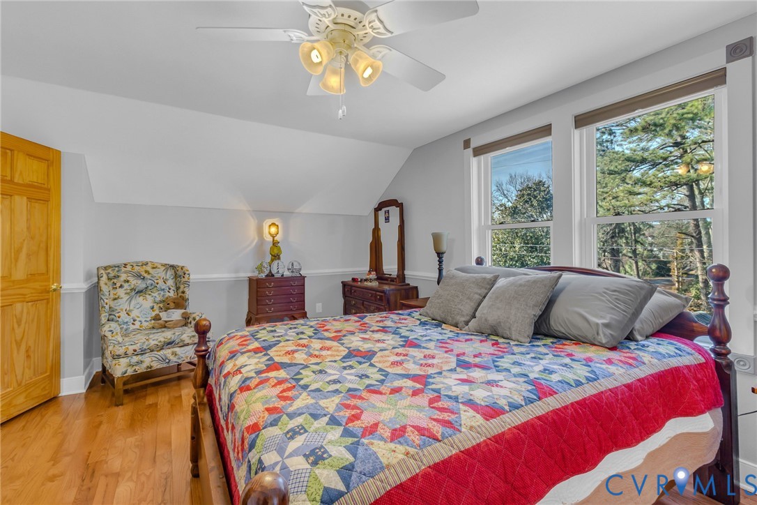273 Sutton Avenue Reedville, VA 22539 - Photo 26 of 50 a bedroom with a bed mirror and window