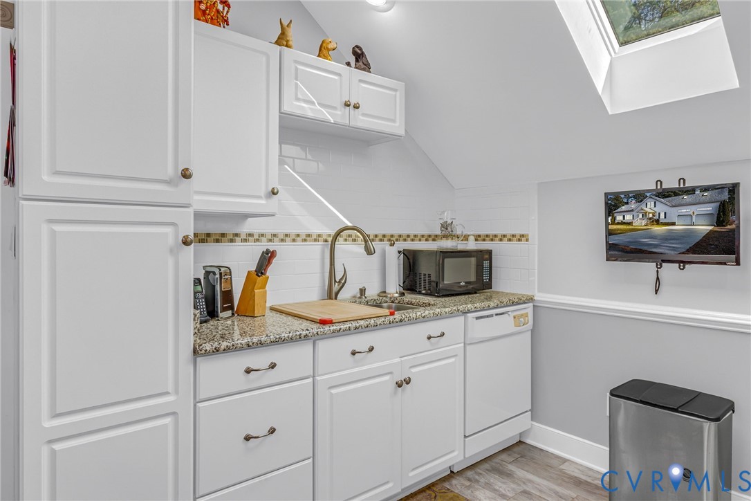 273 Sutton Avenue Reedville, VA 22539 - Photo 36 of 50 a kitchen with cabinets and window