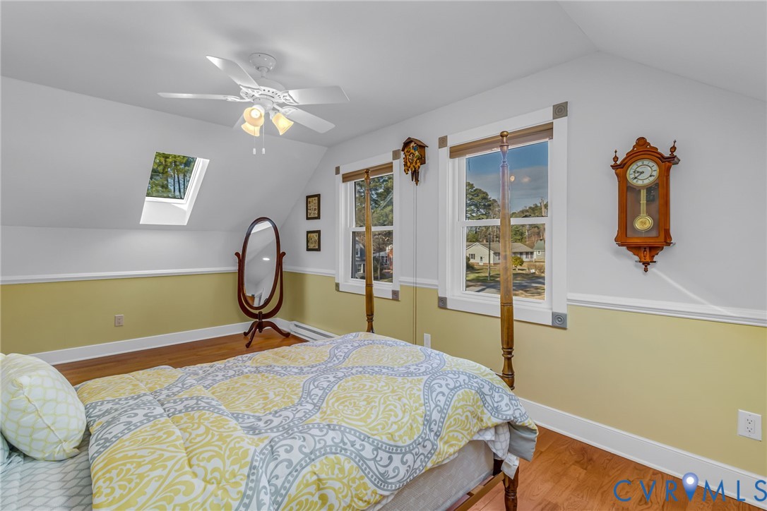 273 Sutton Avenue Reedville, VA 22539 - Photo 40 of 50 a bedroom with a bed and a chandelier