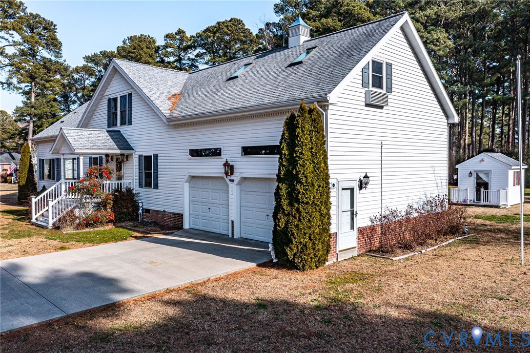 273 Sutton Avenue Reedville, VA 22539 - Photo 45 of 50 a view of a house with a yard and garage