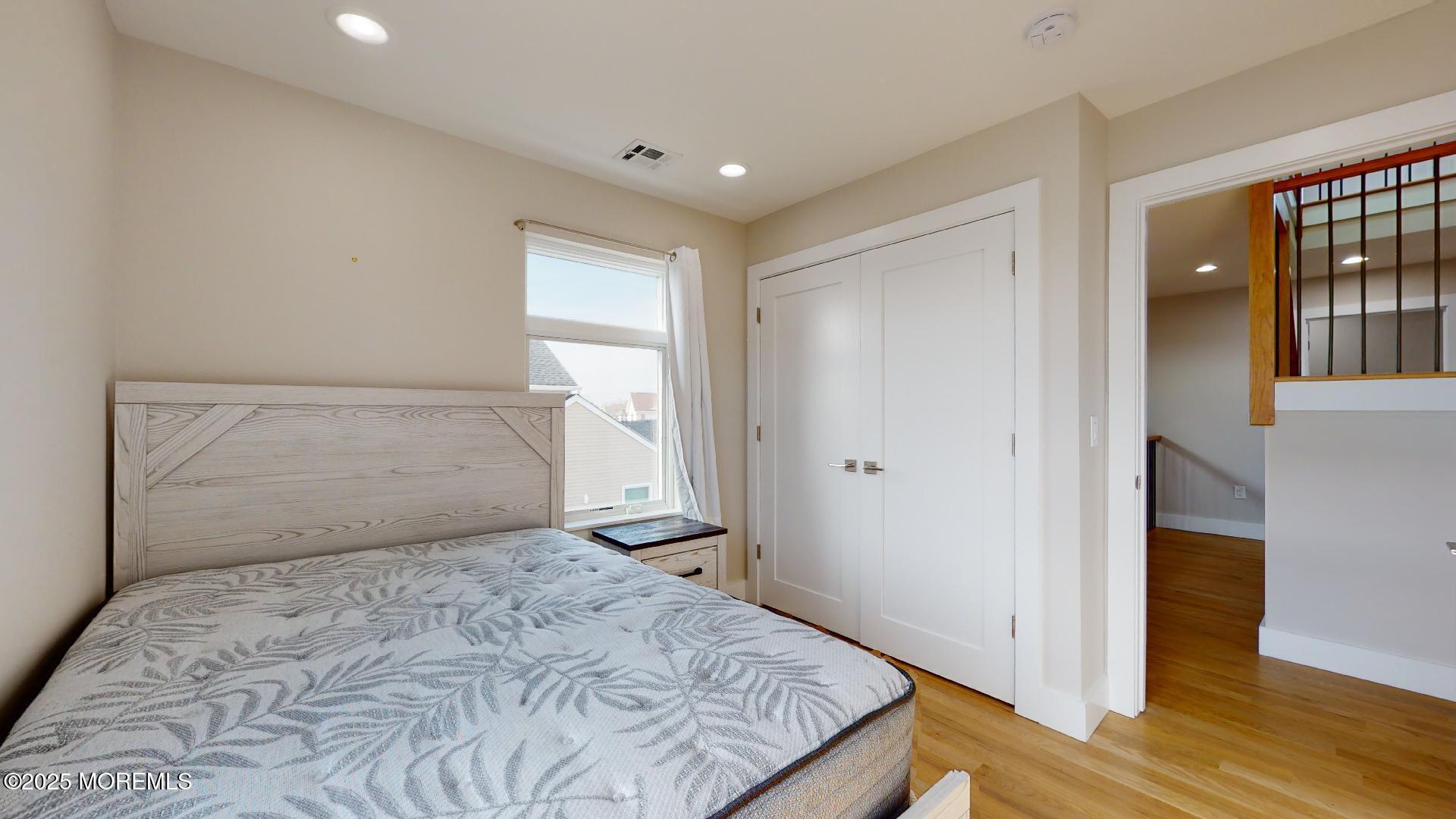 1 Howland Avenue Long Branch, NJ 07740 - Photo 16 of 22 a bedroom with a bed and wooden floor