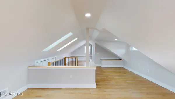 a view of house and hall with wooden floor
