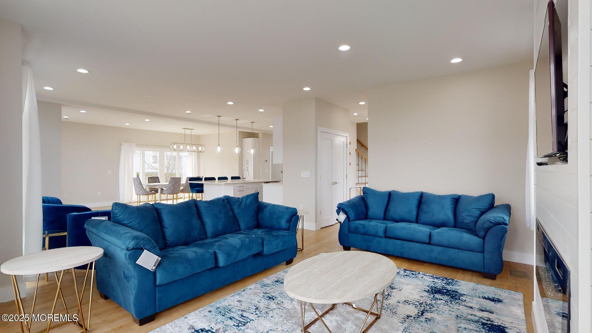 1 Howland Avenue Long Branch, NJ 07740 - Photo 4 of 22 a living room with couches and kitchen view with wooden floor