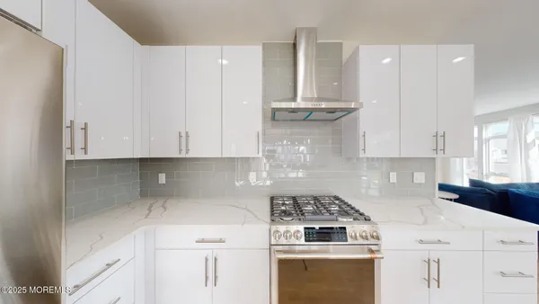 a kitchen with cabinets appliances and a counter space