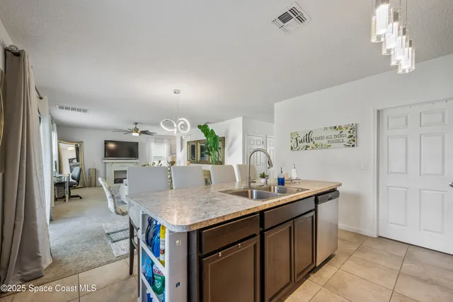 a kitchen with a sink cabinets and stainless steel appliances