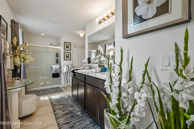 a bedroom with a bed a dresser and a flat screen tv