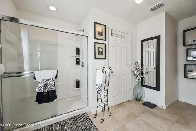 a bathroom with a shower a sink and a mirror