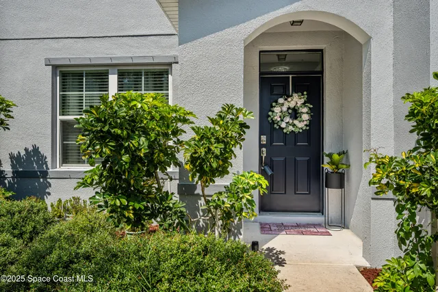 front view of a house with potted plants