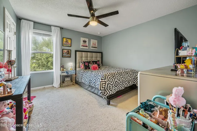 a bed room with a bed and a potted plant