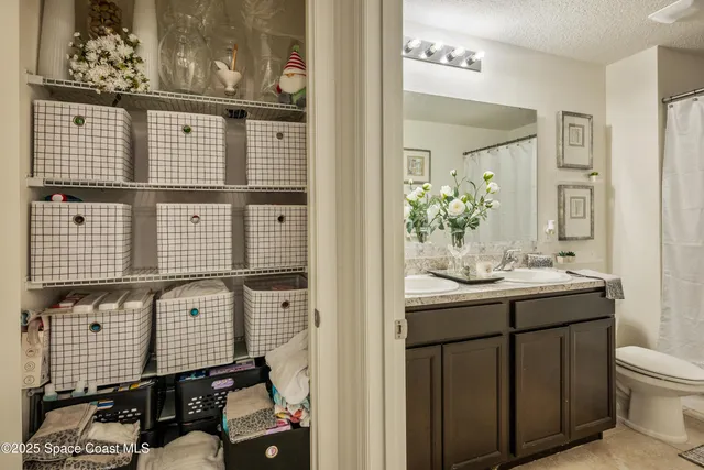 a bathroom with a double vanity sink toilet and shower