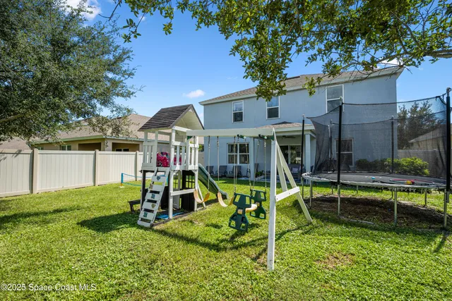 a swimming pool with outdoor seating and yard