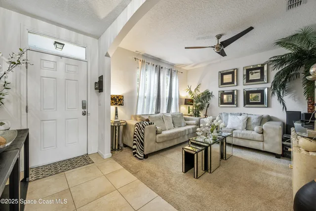 a living room with furniture potted plant and a window
