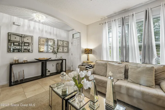 a living room with furniture and large window