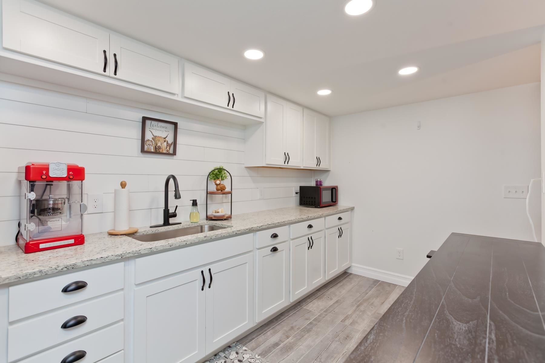 2520 G G 3/8 Road Grand Junction, CO 81505 - Photo 32 of 39 a kitchen with cabinets a sink dishwasher and white cabinets next to window