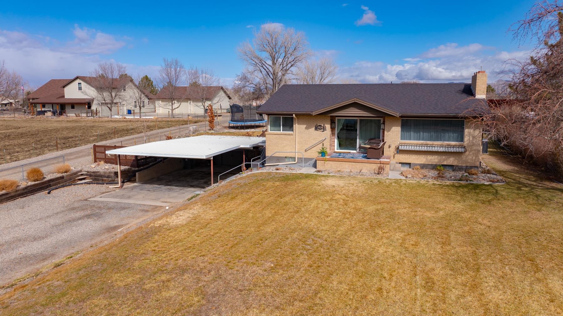 2520 G G 3/8 Road Grand Junction, CO 81505 - Photo 38 of 39 a front view of a house with a yard