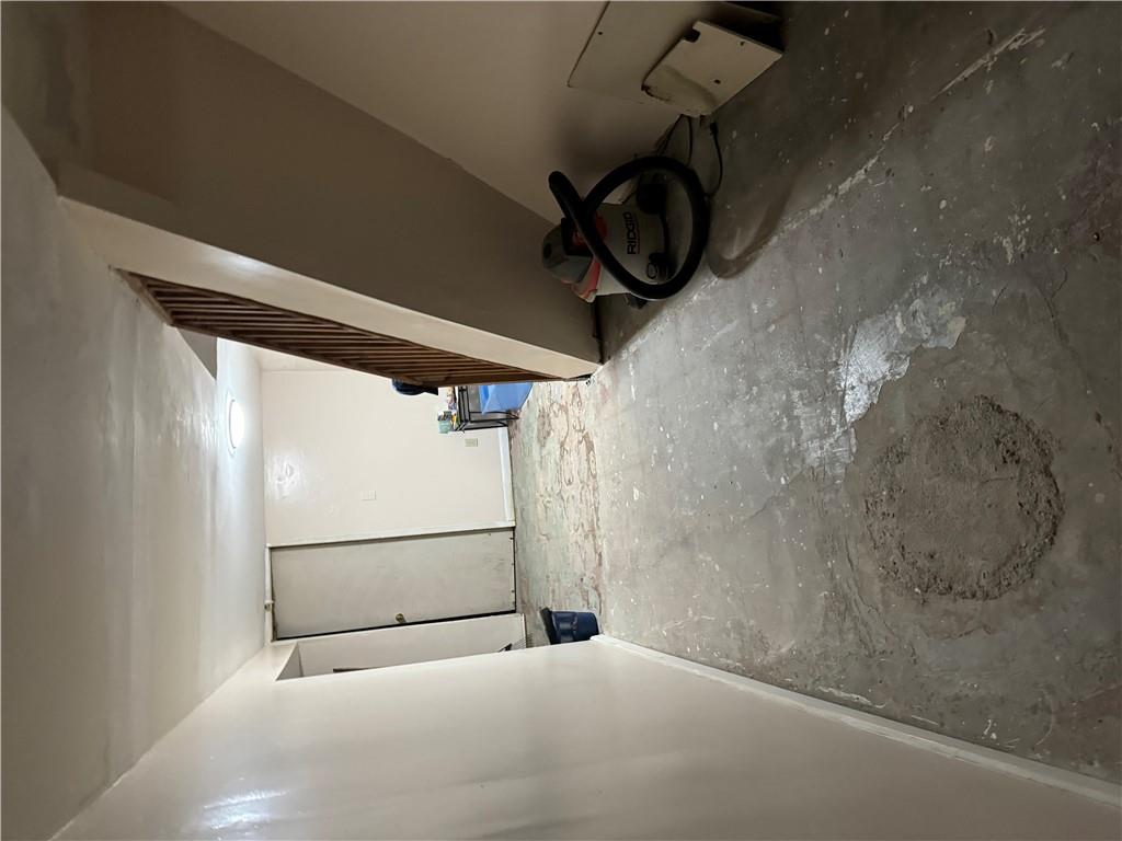 80-13 86th Road Queens, NY 11421 - Photo 17 of 18 a view of a livingroom with wooden floor and stairs