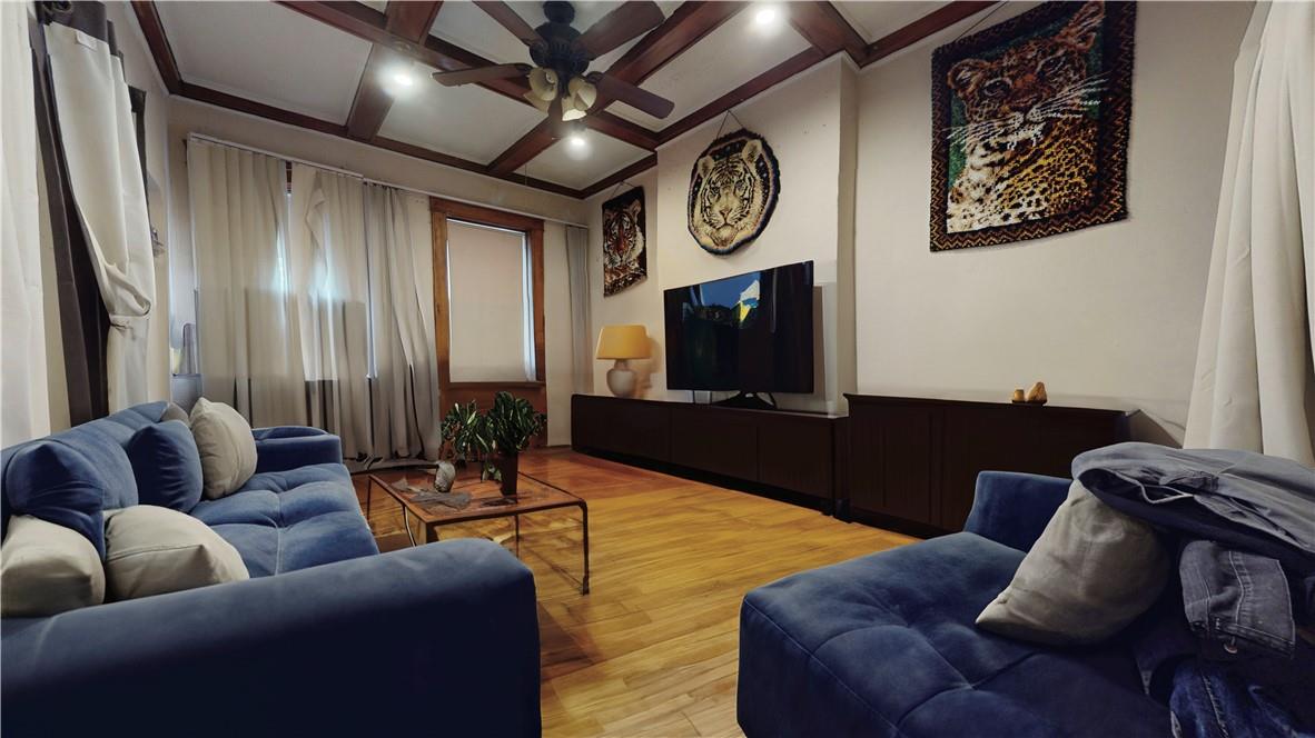 80-13 86th Road Queens, NY 11421 - Photo 2 of 18 a living room with furniture and a flat screen tv