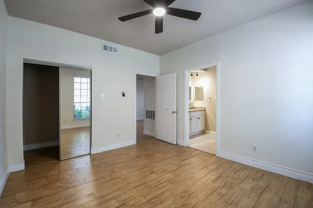 wooden floor in an empty room with a kitchen