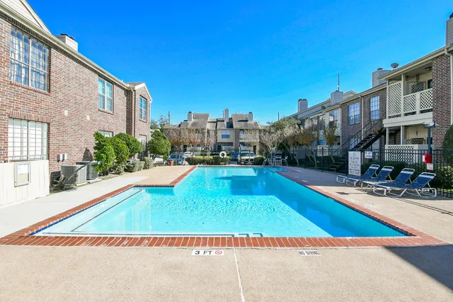 a view of a swimming pool with a lounge chairs
