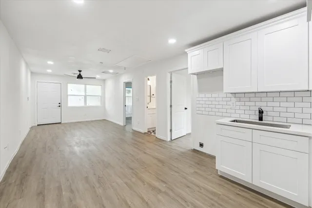 a view of a kitchen with a sink dishwasher stove and cabinets
