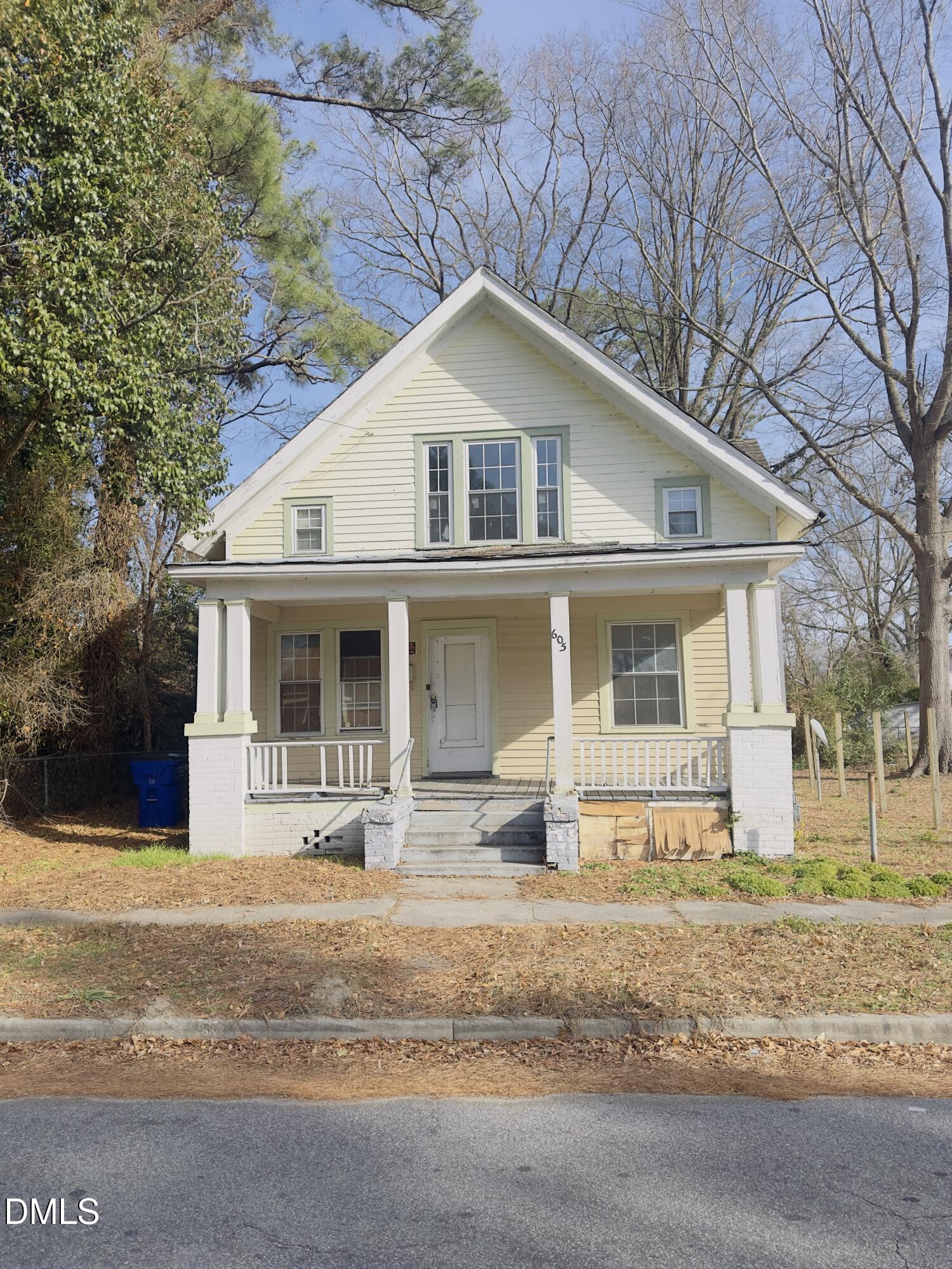 a front view of a house with a yard outdoor seating and garage