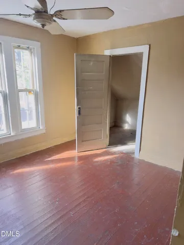 an empty room with windows and closet
