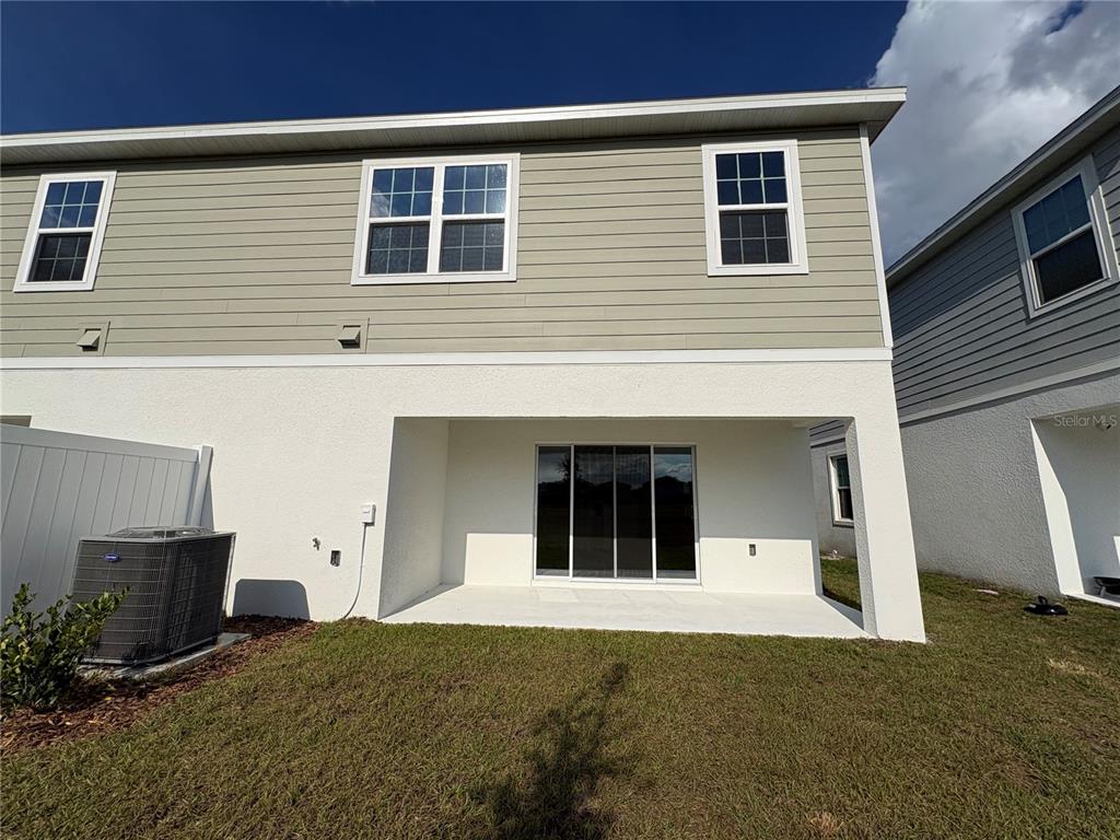 1587 Cloudy Court St. Cloud, FL 34769 - Photo 15 of 16 a front view of a house with a yard and garage