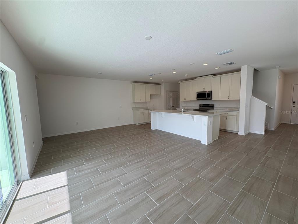 1587 Cloudy Court St. Cloud, FL 34769 - Photo 7 of 16 a view of kitchen with microwave and cabinets