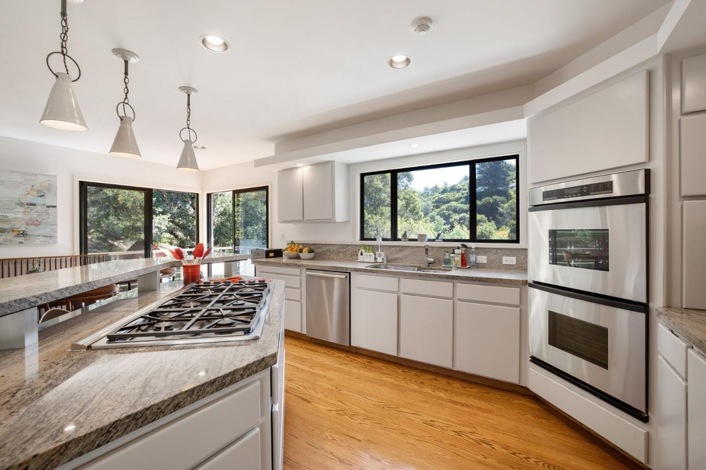1275 La Canada Road Hillsborough, CA 94010 - Photo 23 of 85 a kitchen with a stove a sink dishwasher a refrigerator and white cabinets with wooden floor