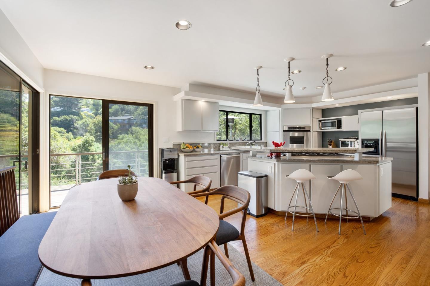 1275 La Canada Road Hillsborough, CA 94010 - Photo 27 of 85 a kitchen with stainless steel appliances kitchen island granite countertop a sink a stove a dining table and chairs