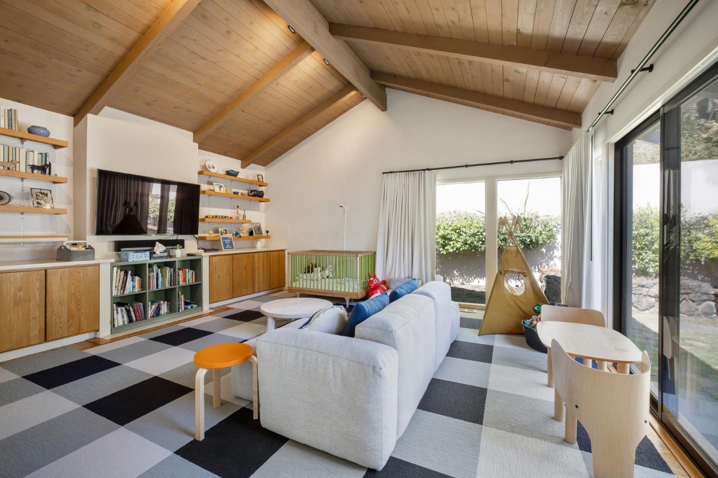 1275 La Canada Road Hillsborough, CA 94010 - Photo 32 of 85 a living room with furniture a flat screen tv and a floor to ceiling window