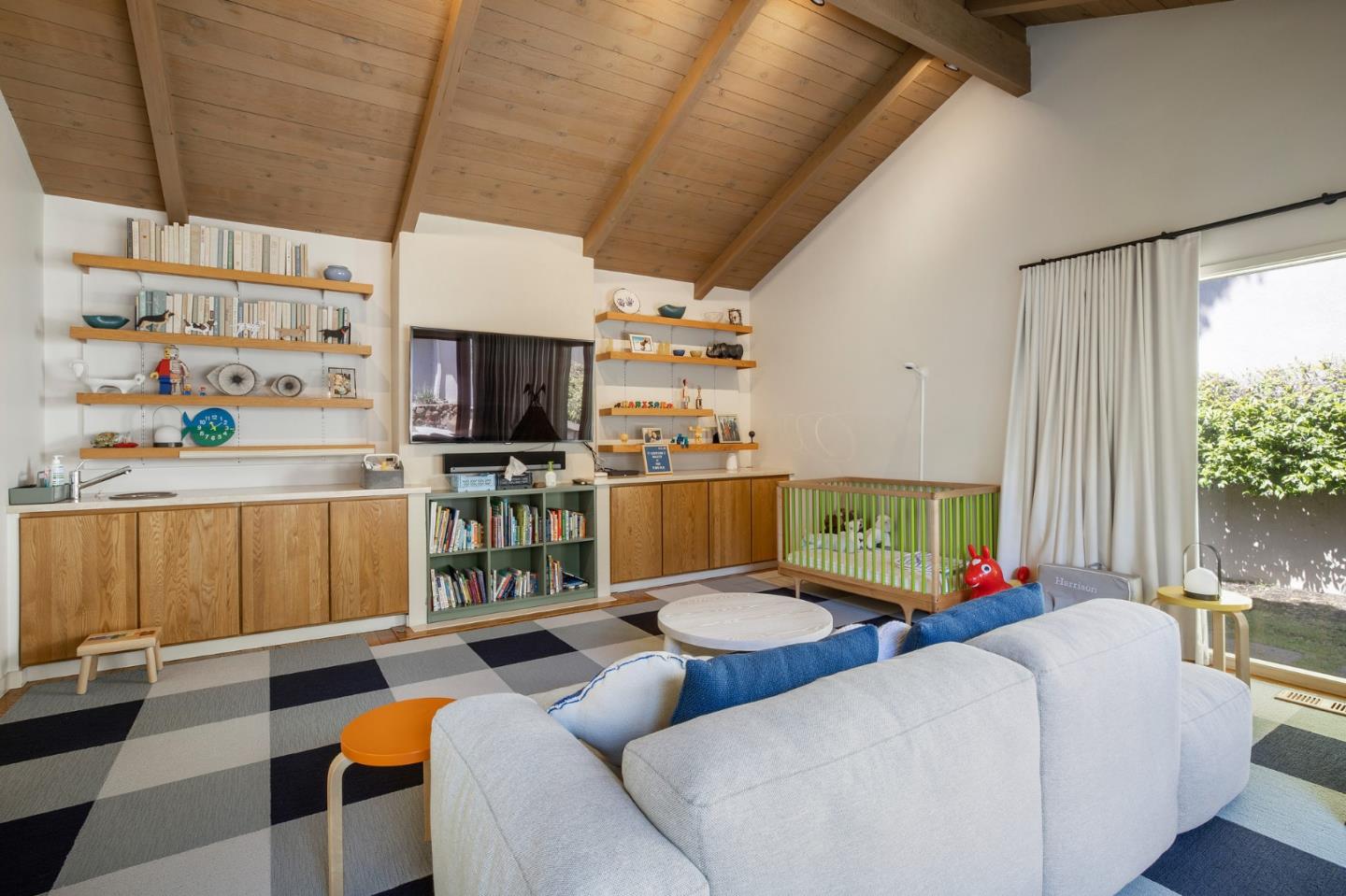 1275 La Canada Road Hillsborough, CA 94010 - Photo 33 of 85 a living room with furniture a flat screen tv and floor to ceiling window