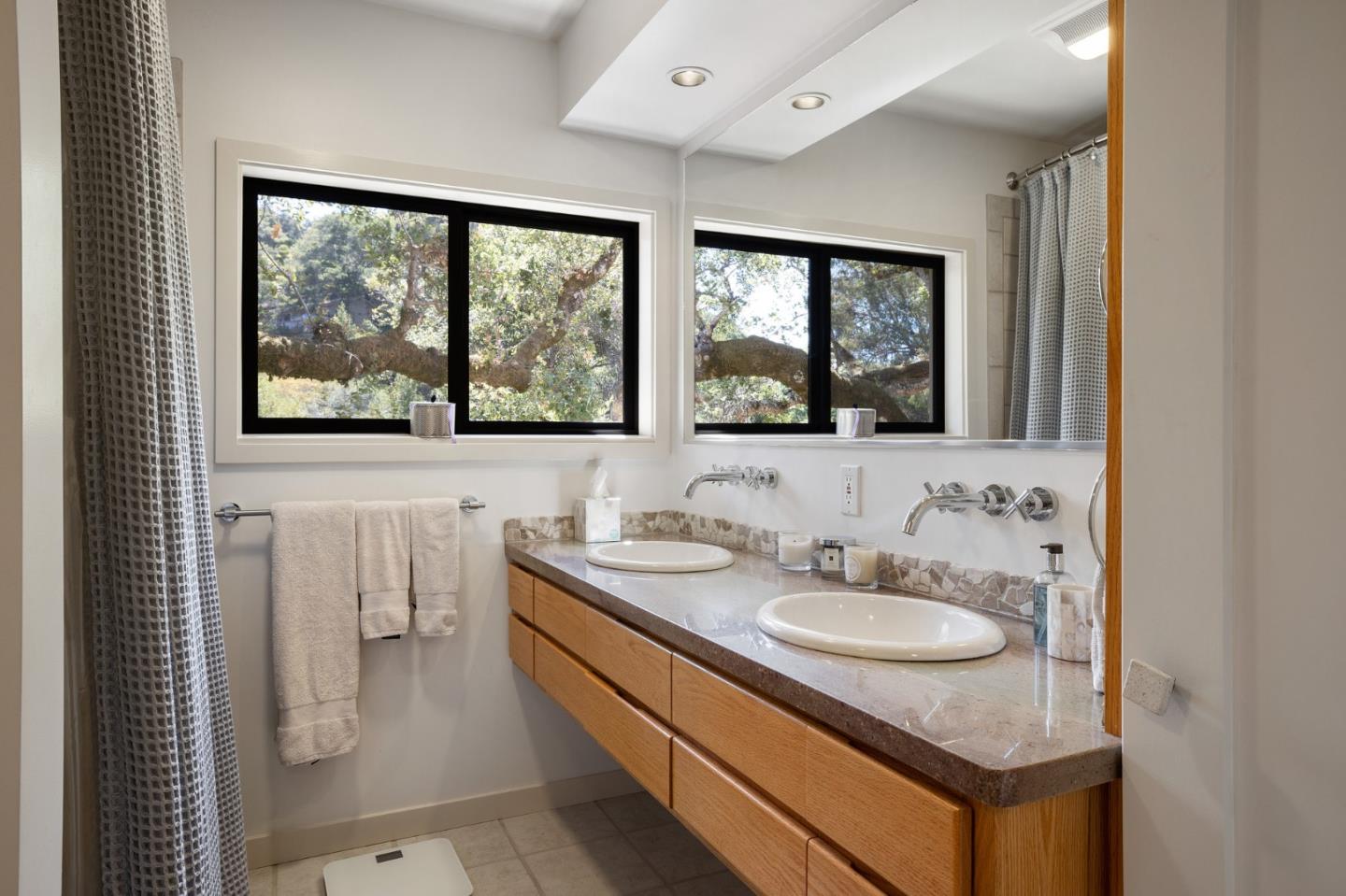 1275 La Canada Road Hillsborough, CA 94010 - Photo 40 of 85 a bathroom with a sink and a mirror next to a window