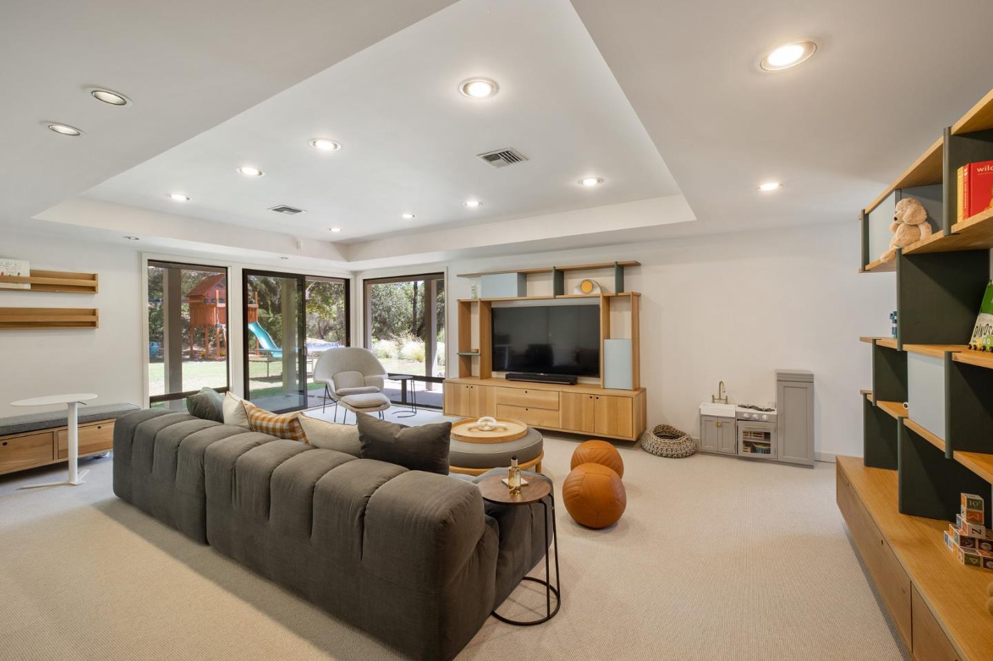1275 La Canada Road Hillsborough, CA 94010 - Photo 45 of 85 a living room with furniture and a flat screen tv