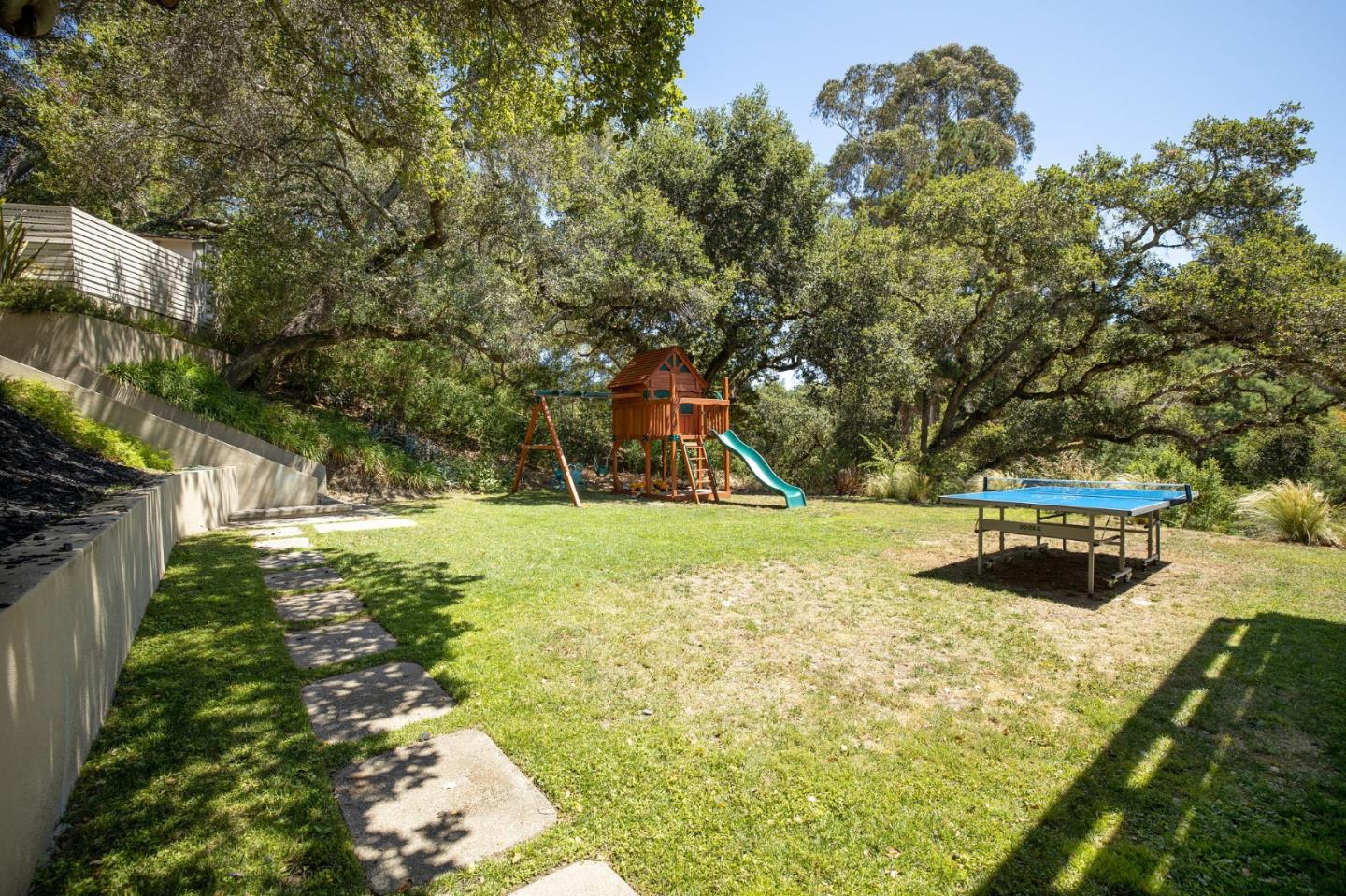 1275 La Canada Road Hillsborough, CA 94010 - Photo 66 of 85 a view of a yard with plants and a bench
