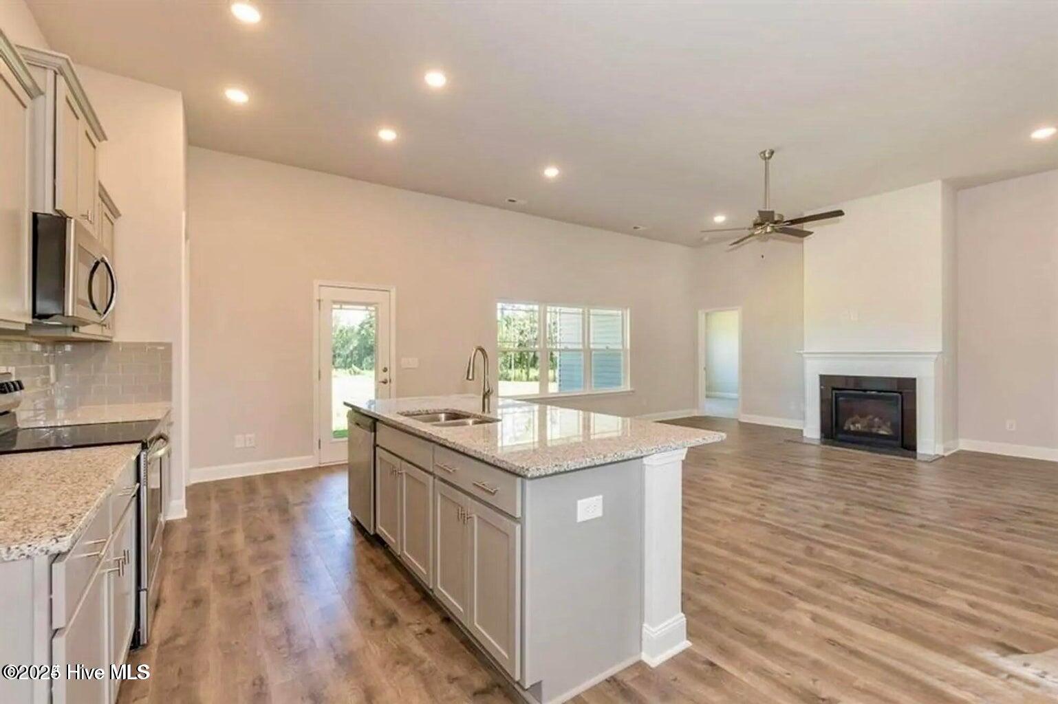 162 Poker House Road Grimesland, NC 27837 - Photo 21 of 27 Kitchen/Living Area. Photos are of the same floor plan in a different community and are for layout and demo purposes only. Upgrades, colors and finishes may differ. Home is currently under construction.