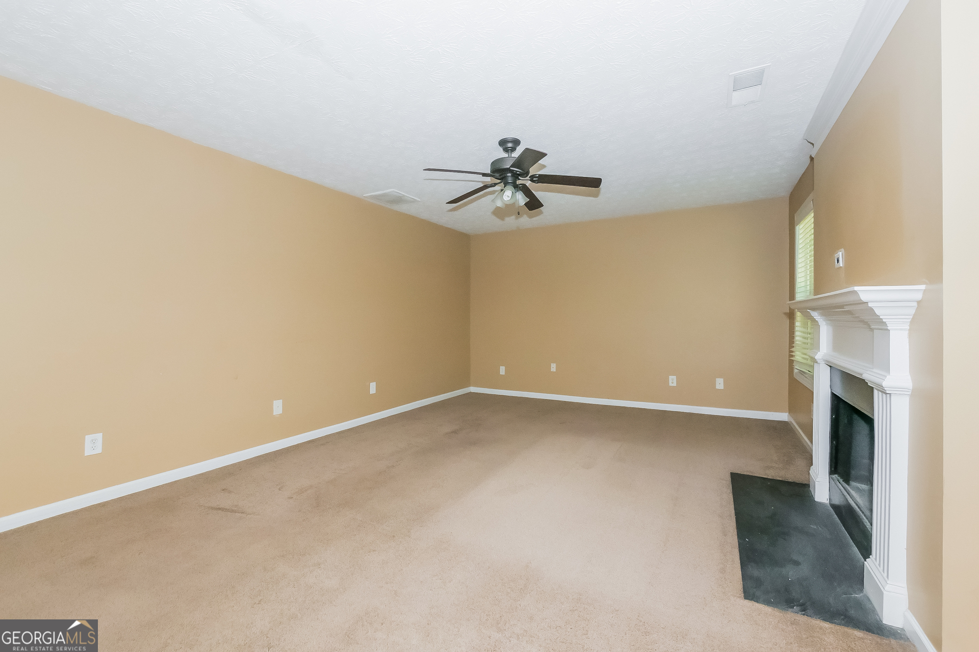 4468 Abram Way Conley, GA 30288 - Photo 3 of 17 a view of an empty room with a fireplace and a window