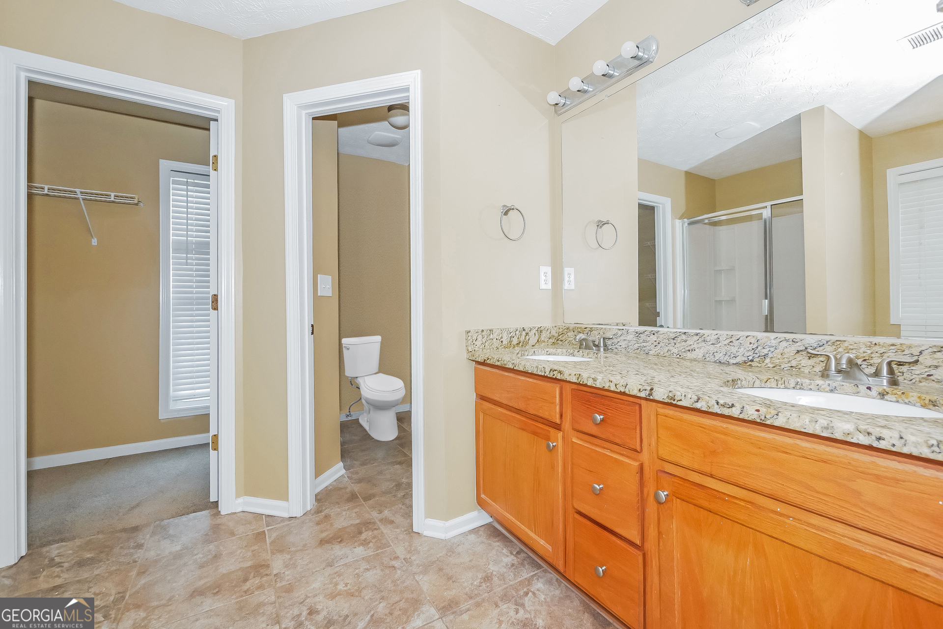 4468 Abram Way Conley, GA 30288 - Photo 10 of 17 a bathroom with a granite countertop sink and a mirror